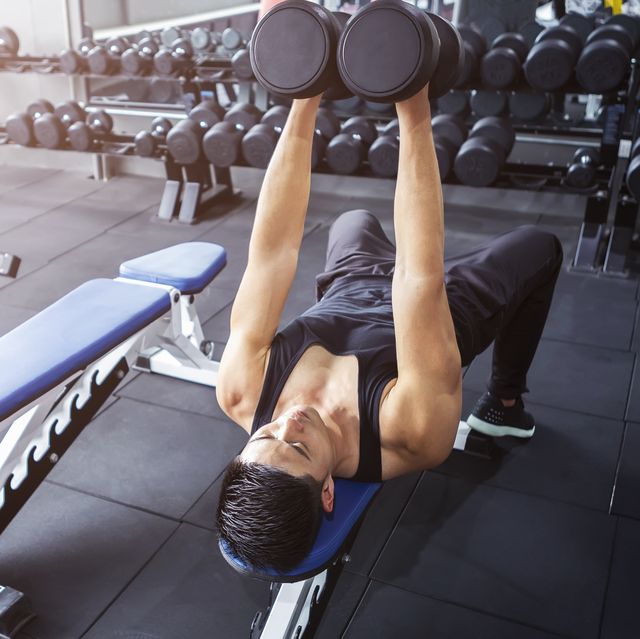 a man workout with dumbbell at gym