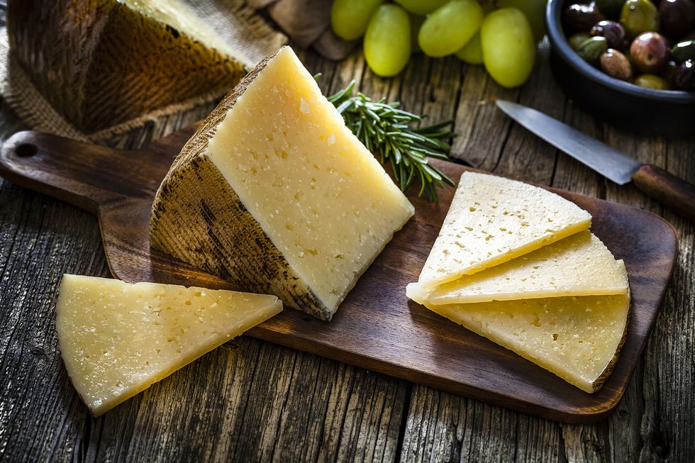spanish food manchego cheese on rustic wooden table