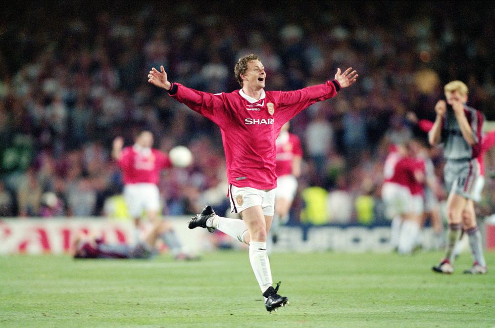 ole gunnar solskjaer lifts his arms into the air as he celebrates winning the treble with manchester united at the uefa champions league final in may 1999