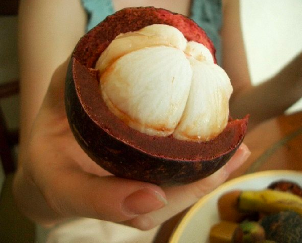 partly peeled mangosteen, closeup