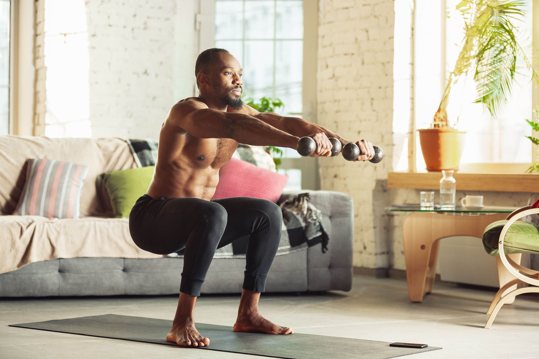 african american man teaching at home online courses of fitness, aerobic, sporty lifestyle while being quarantine getting active while isolated, wellness, movement concept training with weights