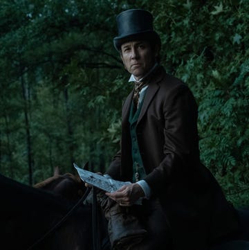 actor tobias menzies wearing a top hat and sitting on a horse portraying edwin stanton in a manhunt tv show scene