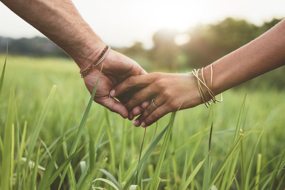 People in nature, Hand, Grass, Gesture, Holding hands, Skin, Grass family, Finger, Arm, Plant, 