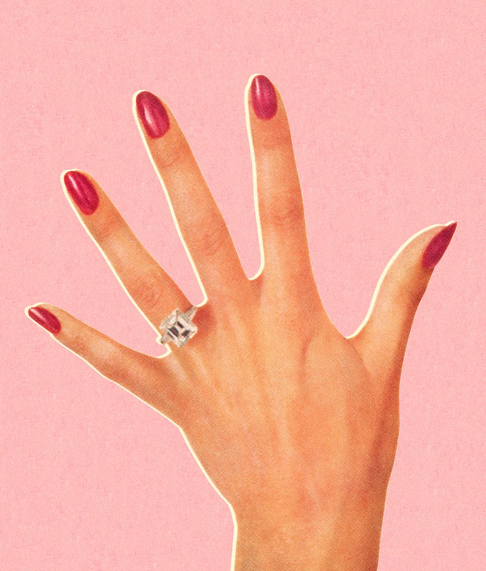 woman's hand wearing engagement ring