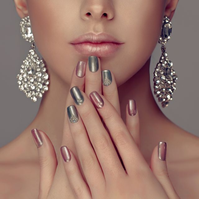 manicure in a silver color on the nails and smokey eyes style make up