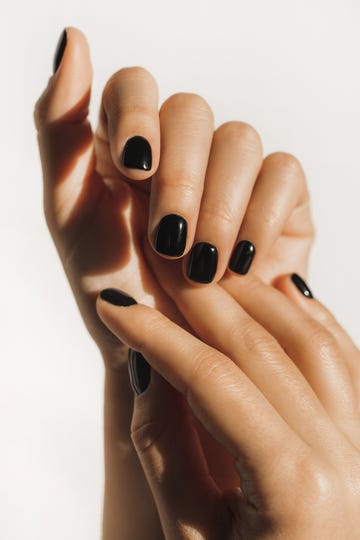 manicure on female hands with black nail polish
