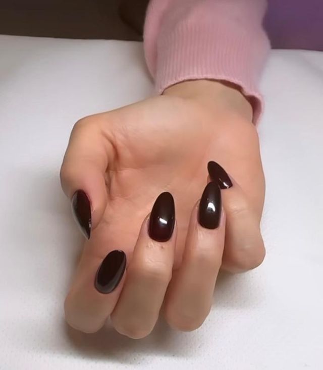 a hand with painted fingernails