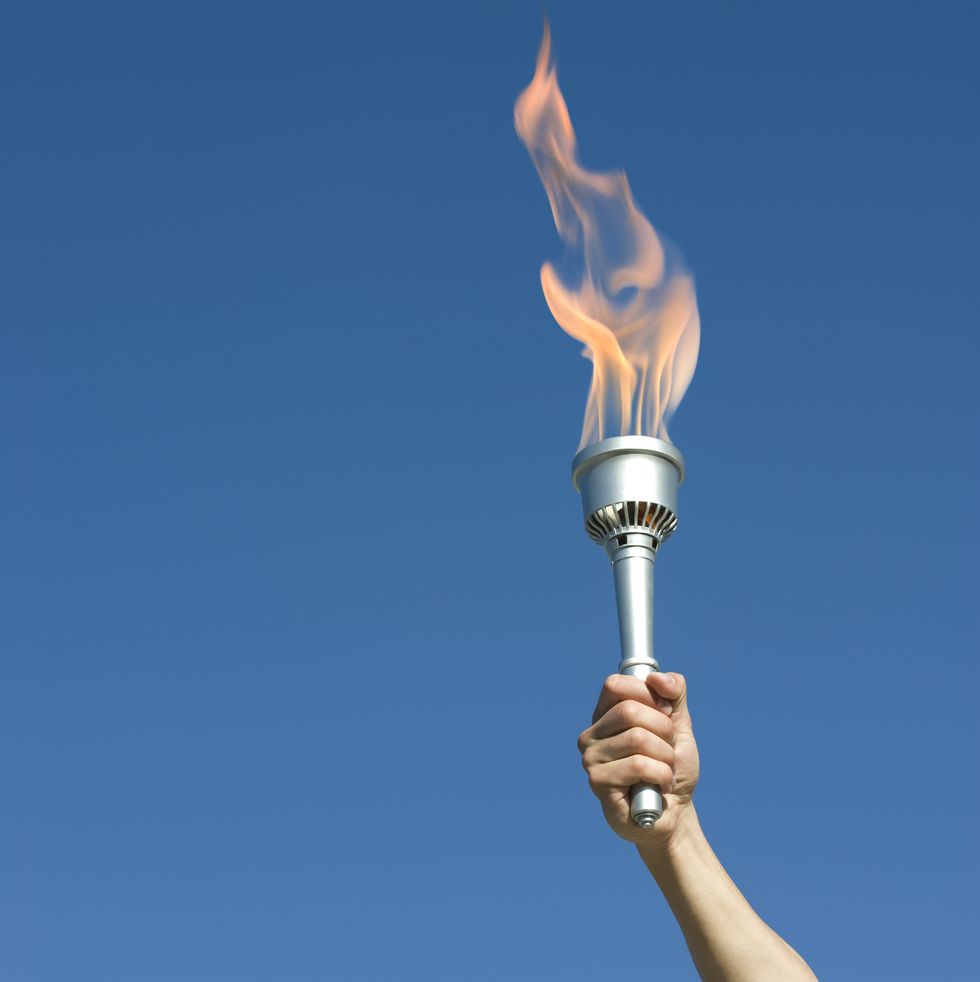 man's arm holding up torch