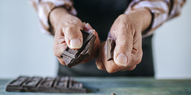 man's hands breaking a chocolate bar, close up