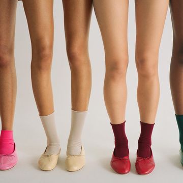 a group of legs in different colored shoes