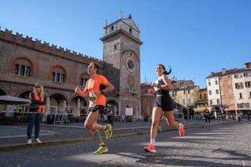runners participating in a race in an urban setting with historical architecture