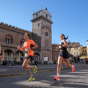 runners participating in a race in an urban setting with historical architecture runners participating in a race in an urban setting with historical architecture