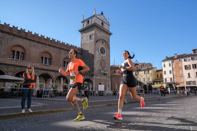 runners participating in a race in an urban setting with historical architecture