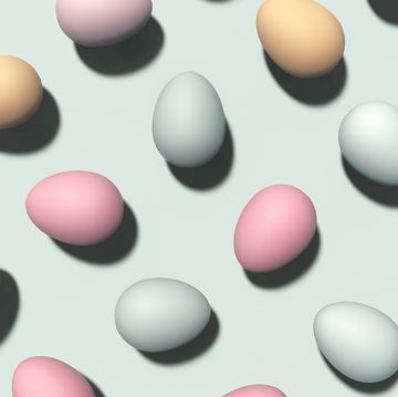many different colored eggs on pastel blue background festive easter pattern flat lay, top view