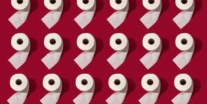 many toilet rolls on red background