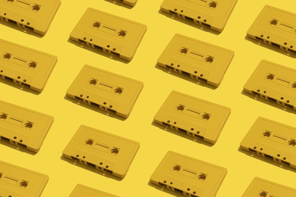 many yellow cassette tapes on yellow background