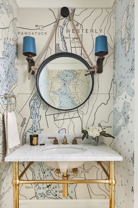 Small bathroom with map wallpaper and mirror
