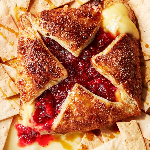 wrapped baked brie topped with cranberry and maple and served with crackers