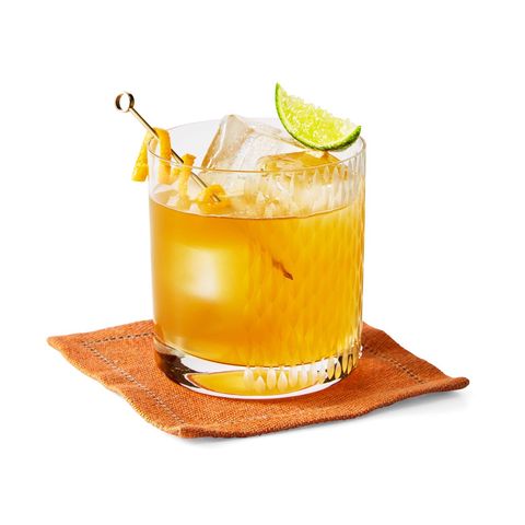 maple whiskey sour with orange peel on stirrer