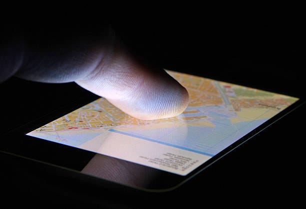 finger touching navigation map on touch screen smart phone device