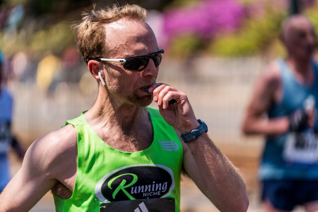 runner eating energy gel during boston marathon