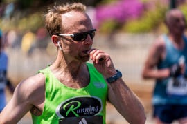 runner eating energy gel during boston marathon