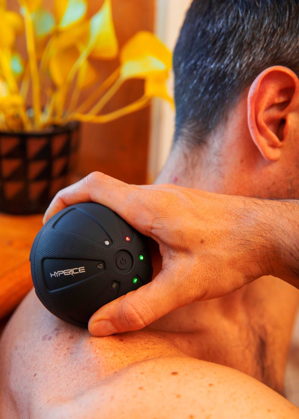 Runner with Hyperice on his shoulder.
