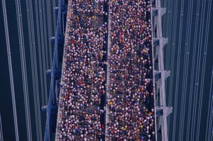 Marathon runners jogging across bridge, elevated view