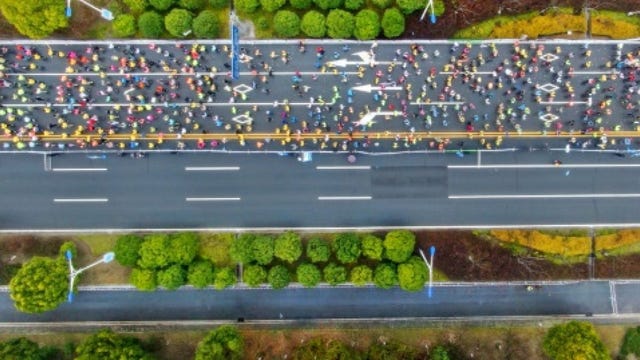 chinese runner banned for cycling during marathon