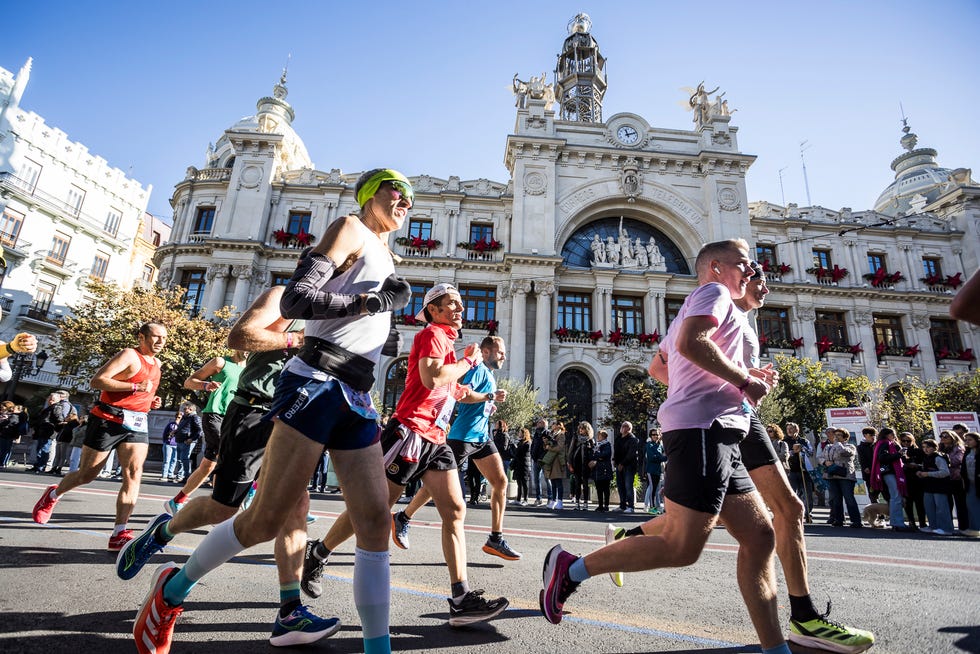 Runners participating in a marathon with a historic building in the background