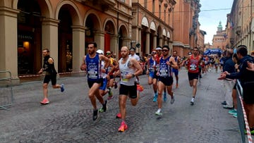 a group of people running in a street