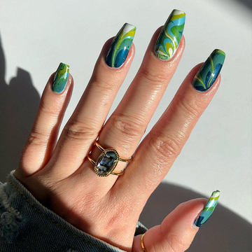 two hands with marble nail designs