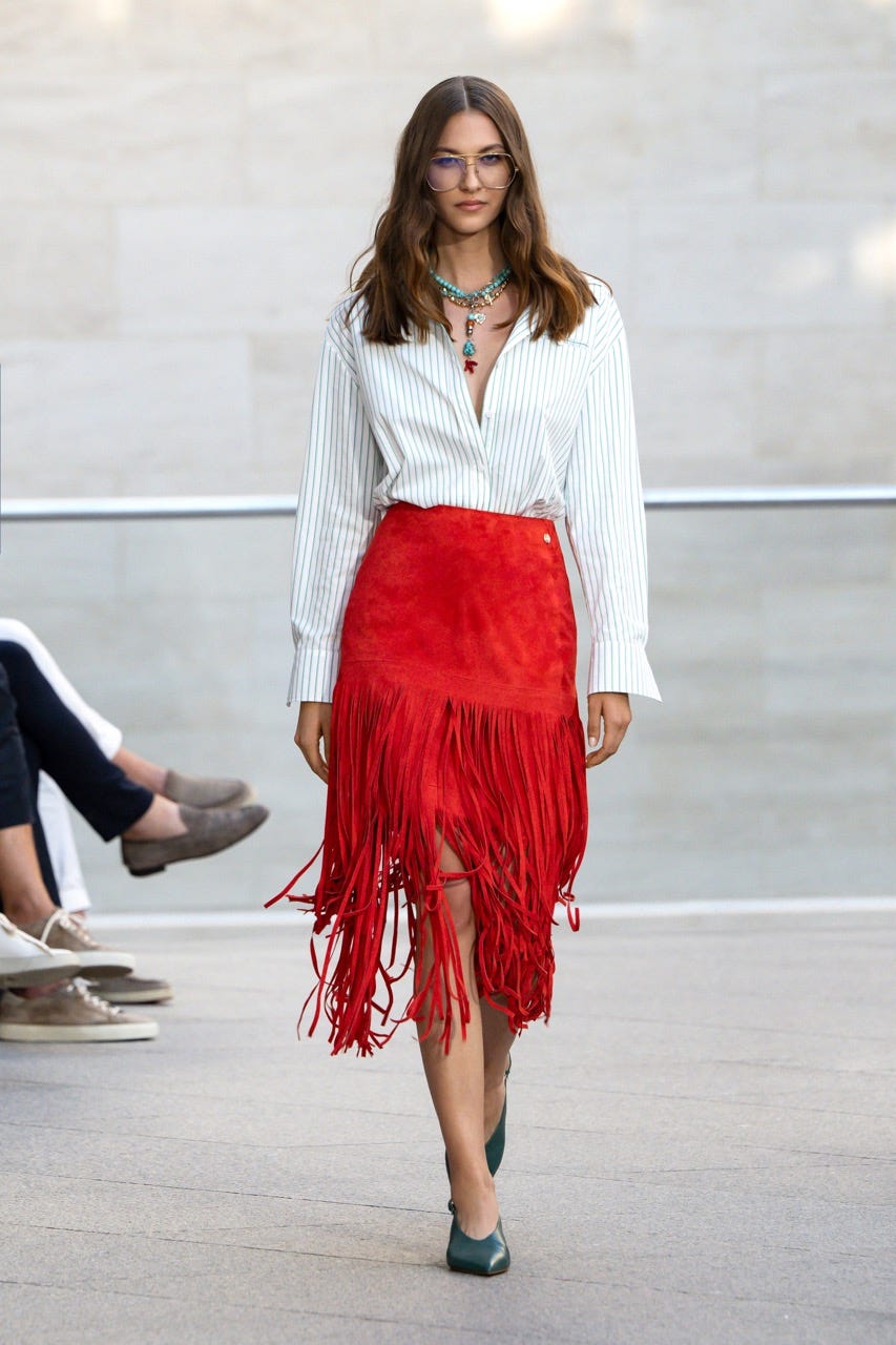 Fashion model displays elegant outfit on a runway