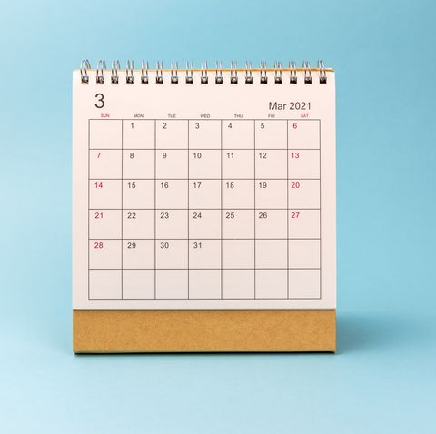march 2021 desk calendar on blue background