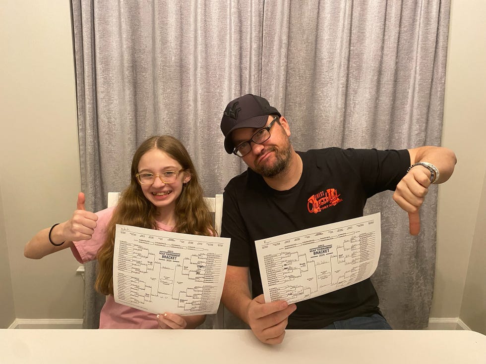 japanese father and daughter filling out paperwork on kitchen table
