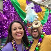 happy latin tourists friends heterosexual couple celebrating their honeymoon in mardi gras in new orleans dressing necklace and masks mardi gras is the most important celebration for the city