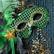 mardi gras mask on beaded green background
