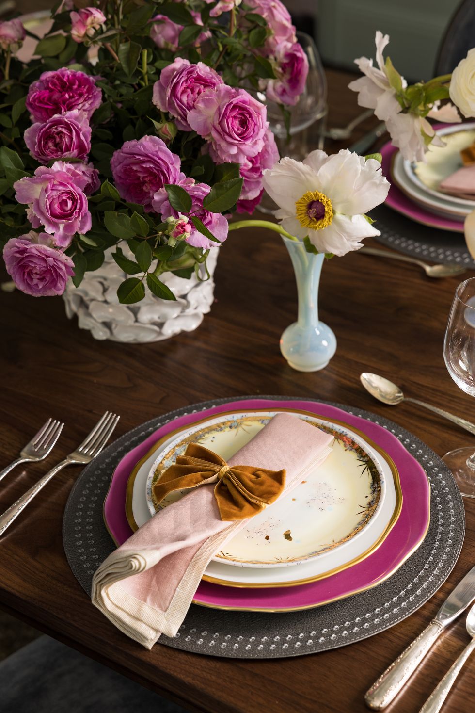 a table setting with purple and pink plates