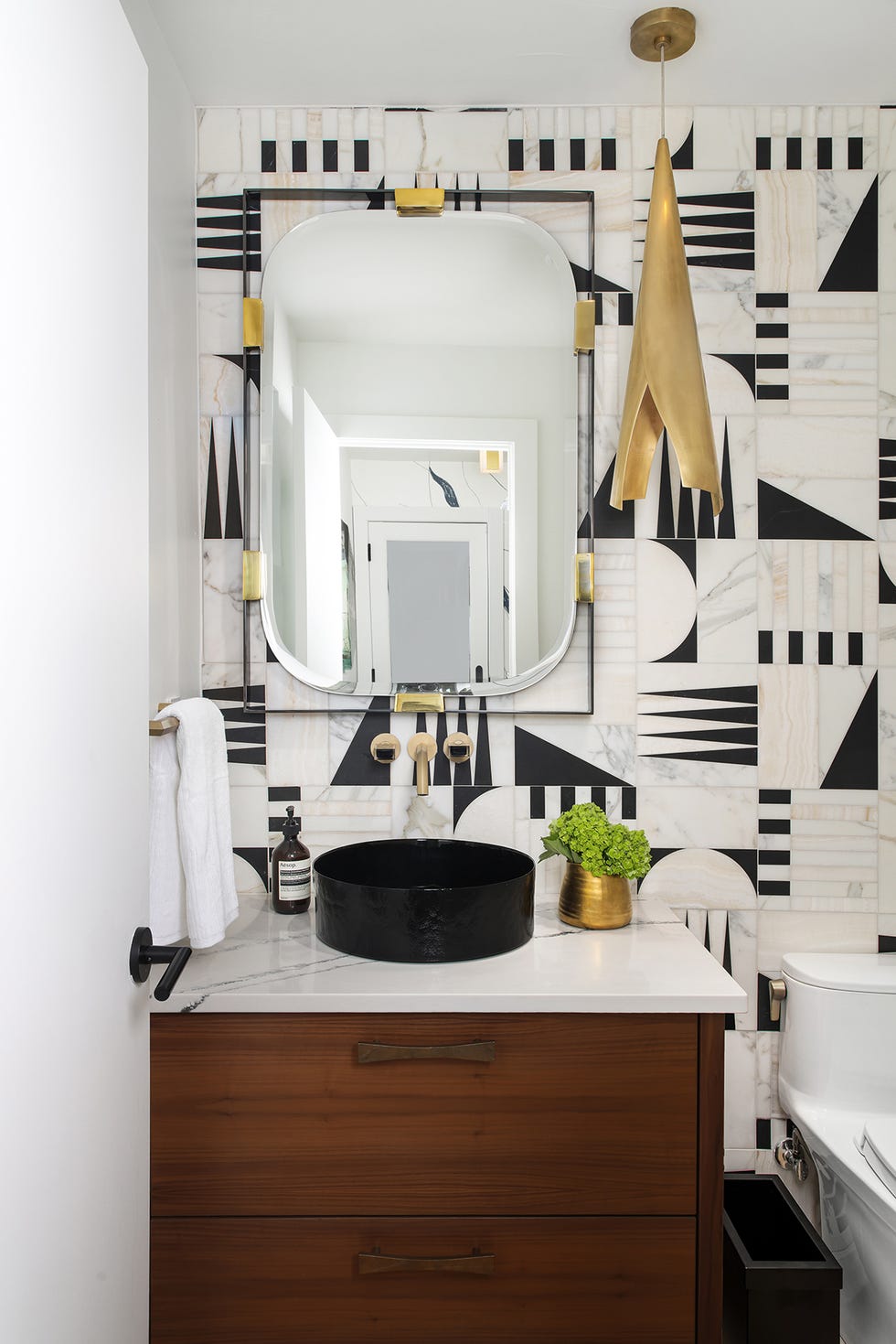 modern bathroom with geometric tile black basin and gold accents