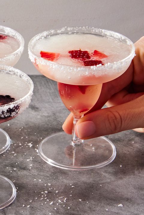 blackberry, raspberry, pineapple, and strawberry slushy margaritas in margarita style shot glasses
