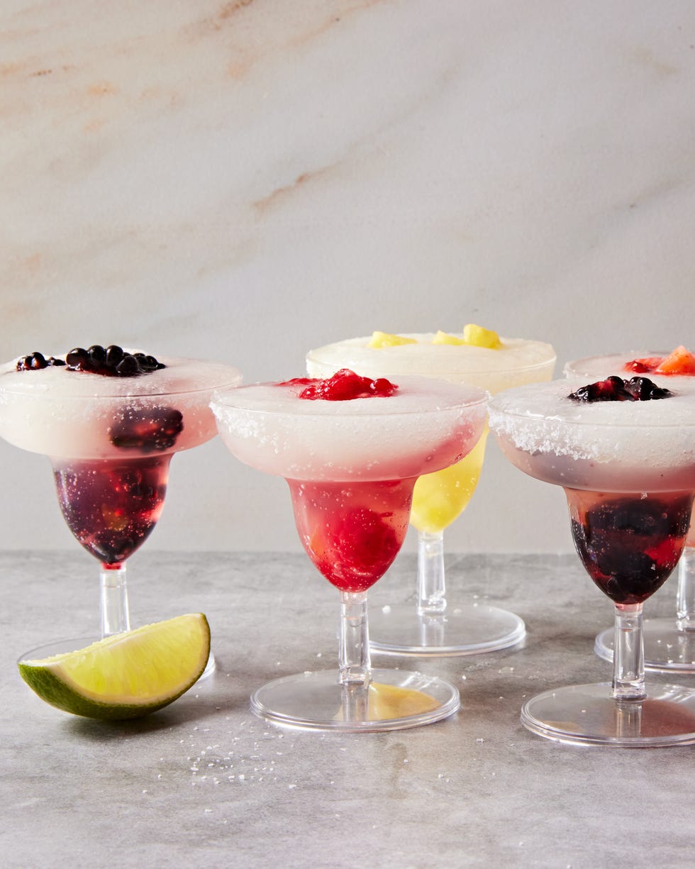 blackberry, raspberry, pineapple, and strawberry slushy margaritas in margarita style shot glasses