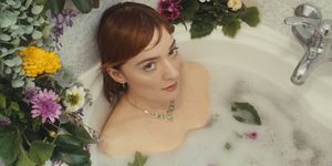 a woman in a bathtub with flowers