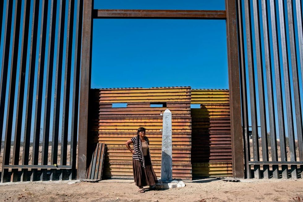 maria guadalupe arvallo, a member of pai pai indigenous group, stands next to a section of the us mexico border fence at indigenous lands, east of tecate, baja california state, mexico