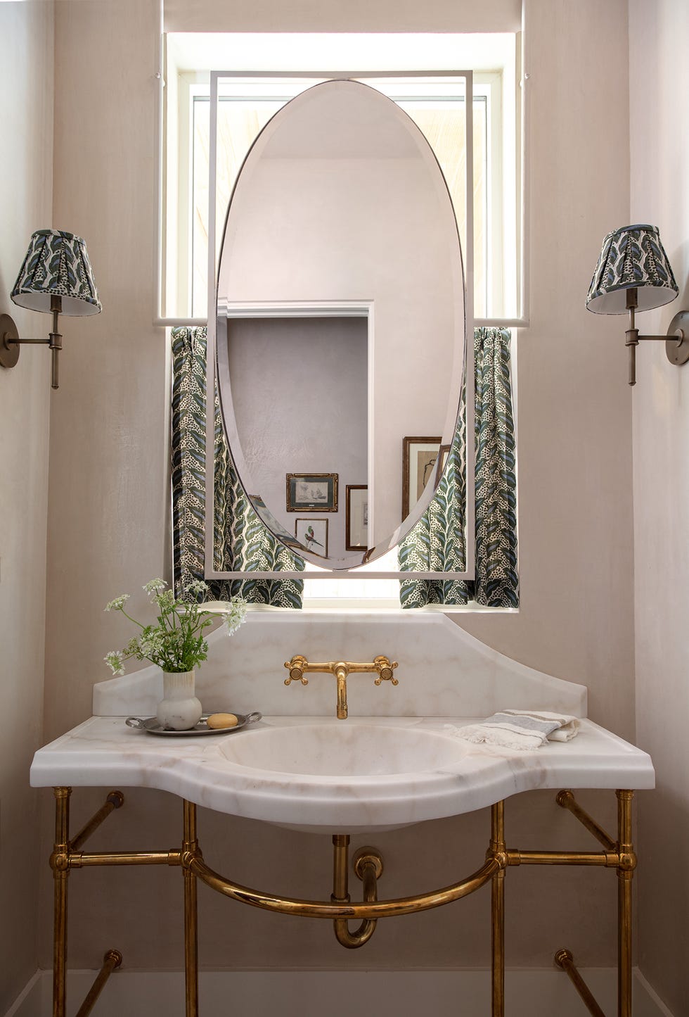 elegant bathroom vanity with a marble sink and gold fixtures