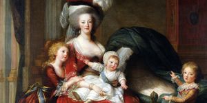 marie antoinette sits and holds one of her children on her lap, another of her children hugs her, and a third stands nearby at the end of baby crib