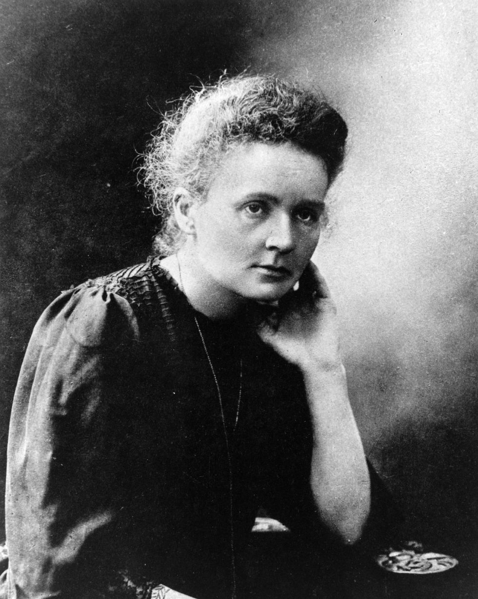 marie curie sitting with her head resting on her left hand in a photograph