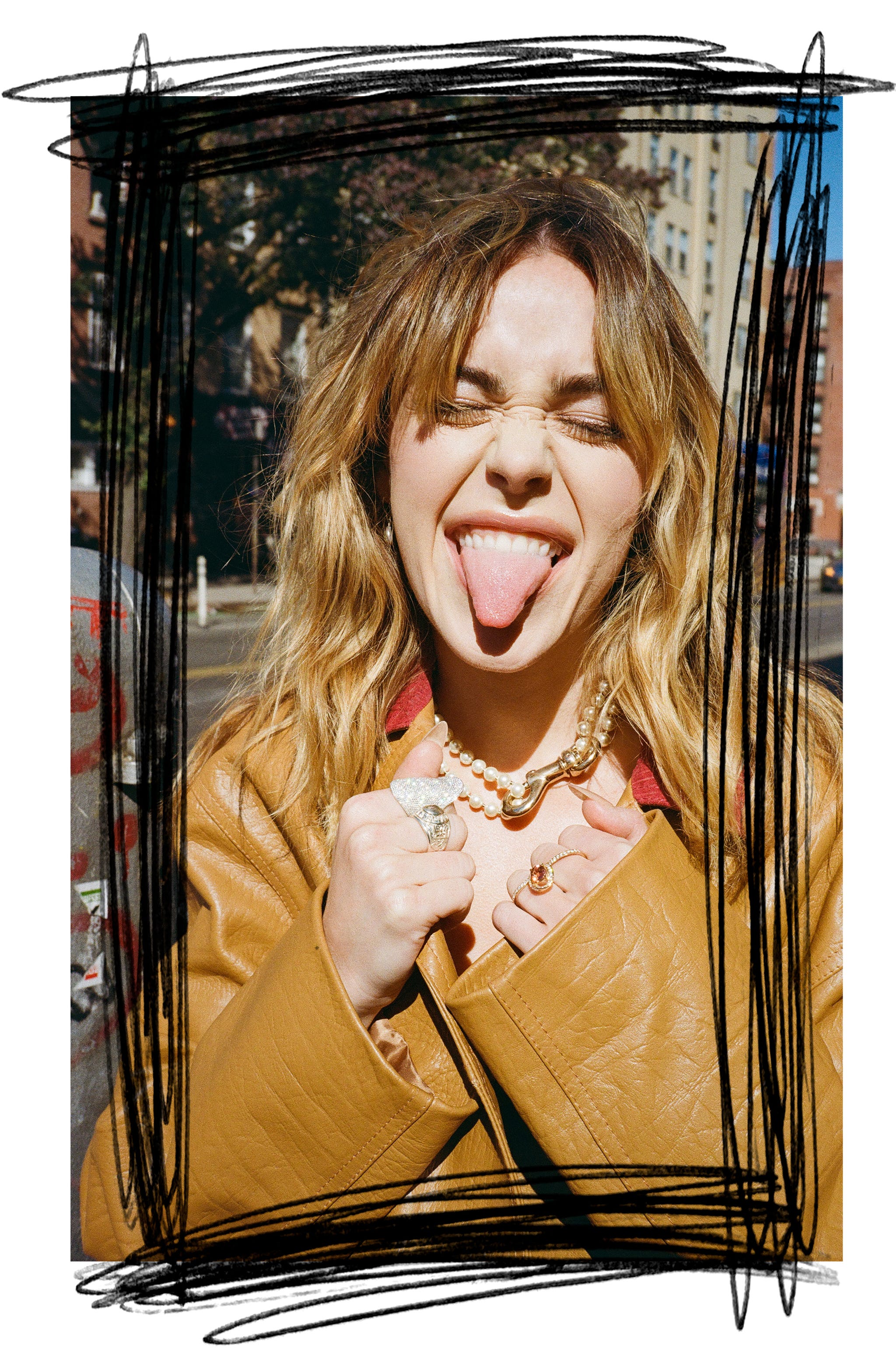 a person wearing a brown leather jacket showcasing jewelry