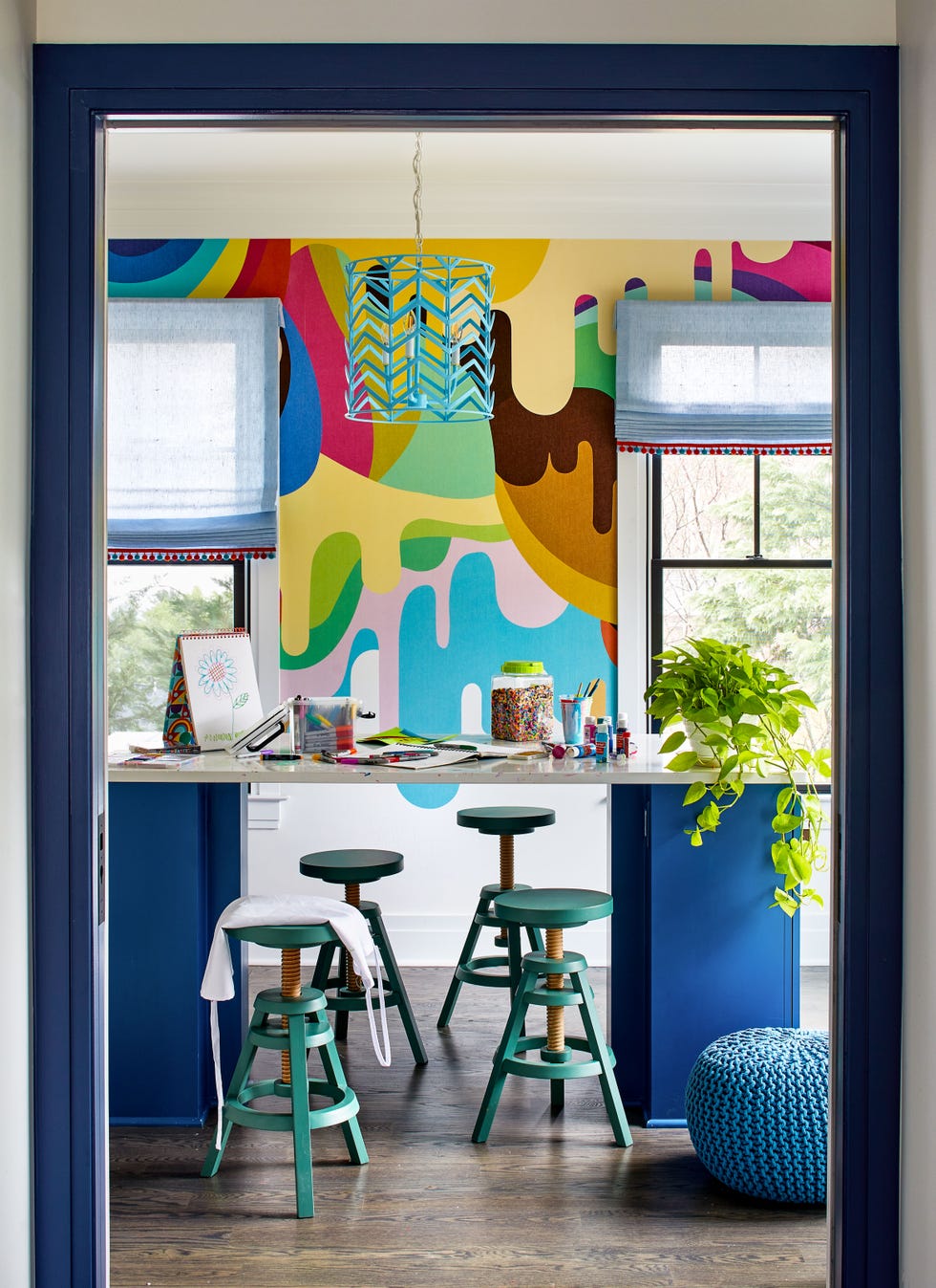 a room with stools and a window with a painting on it