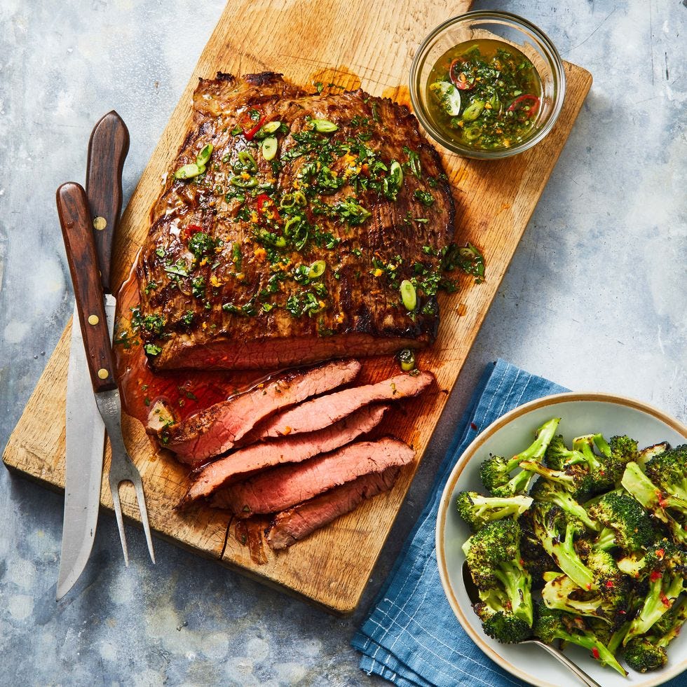 marinated flank steak on a wooden slab