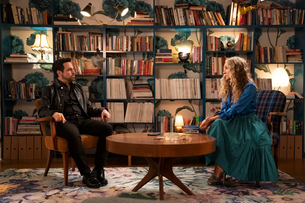 a cozy interior scene with two individuals engaged in conversation